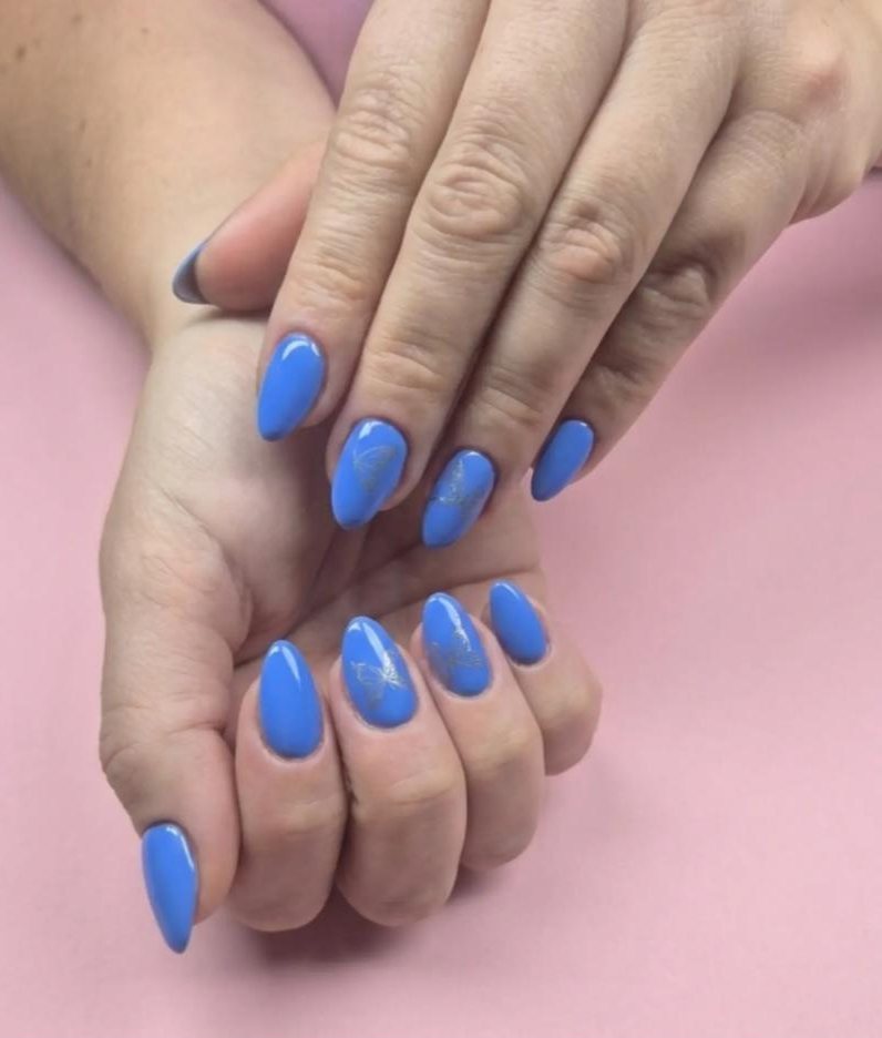 Cornflower blue almond nails with a silver butterfly detail